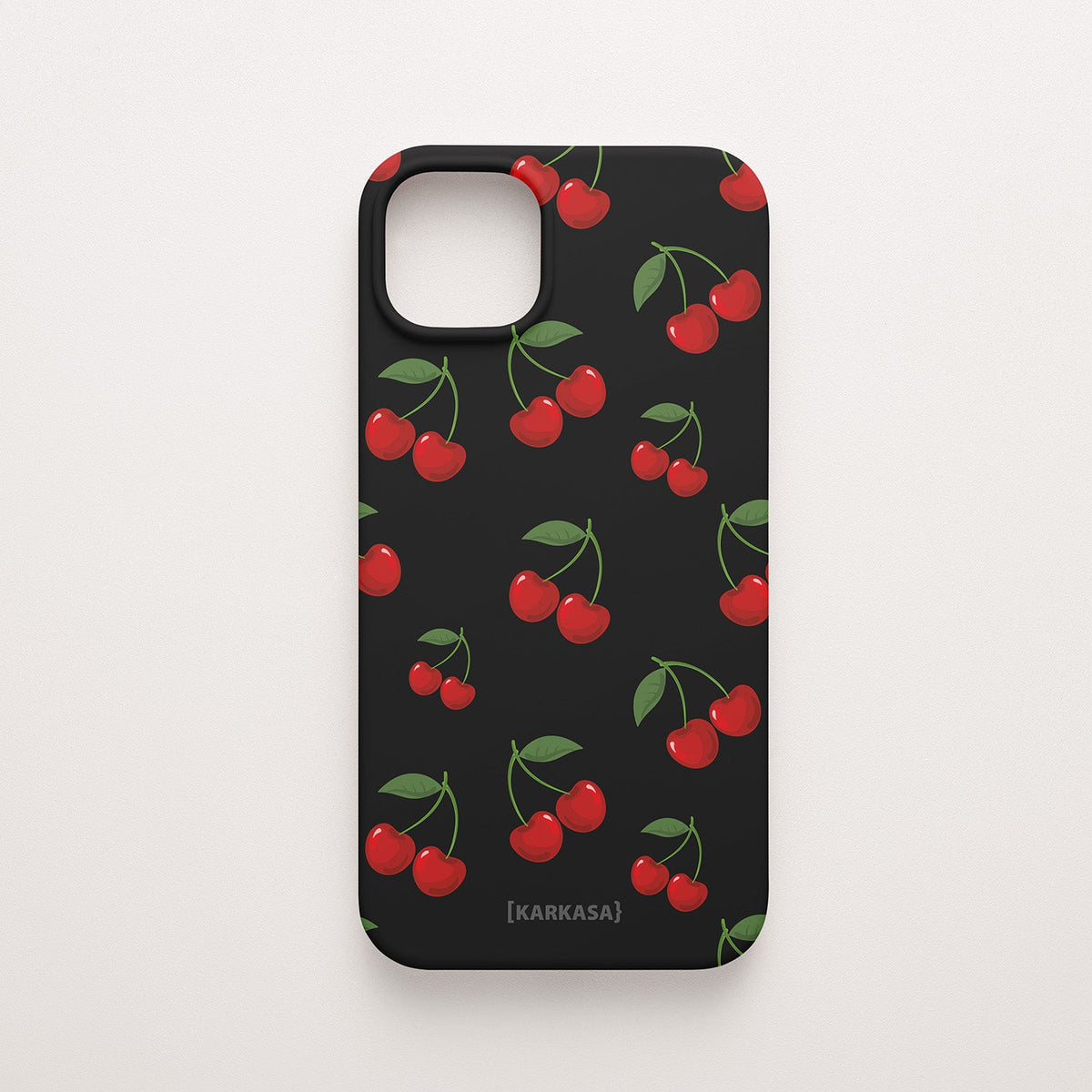 Funda KARKASA Silk Touch negra con estampado pop de cerezas rojas y hojas verdes. Carcasa estilo frutal aesthetic.