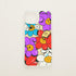 Funda de móvil transparente con estampado de flores sonrientes moradas, azules, rojas y blancas, diseño Color Combo de Chetone Sánchez para KARKASA.