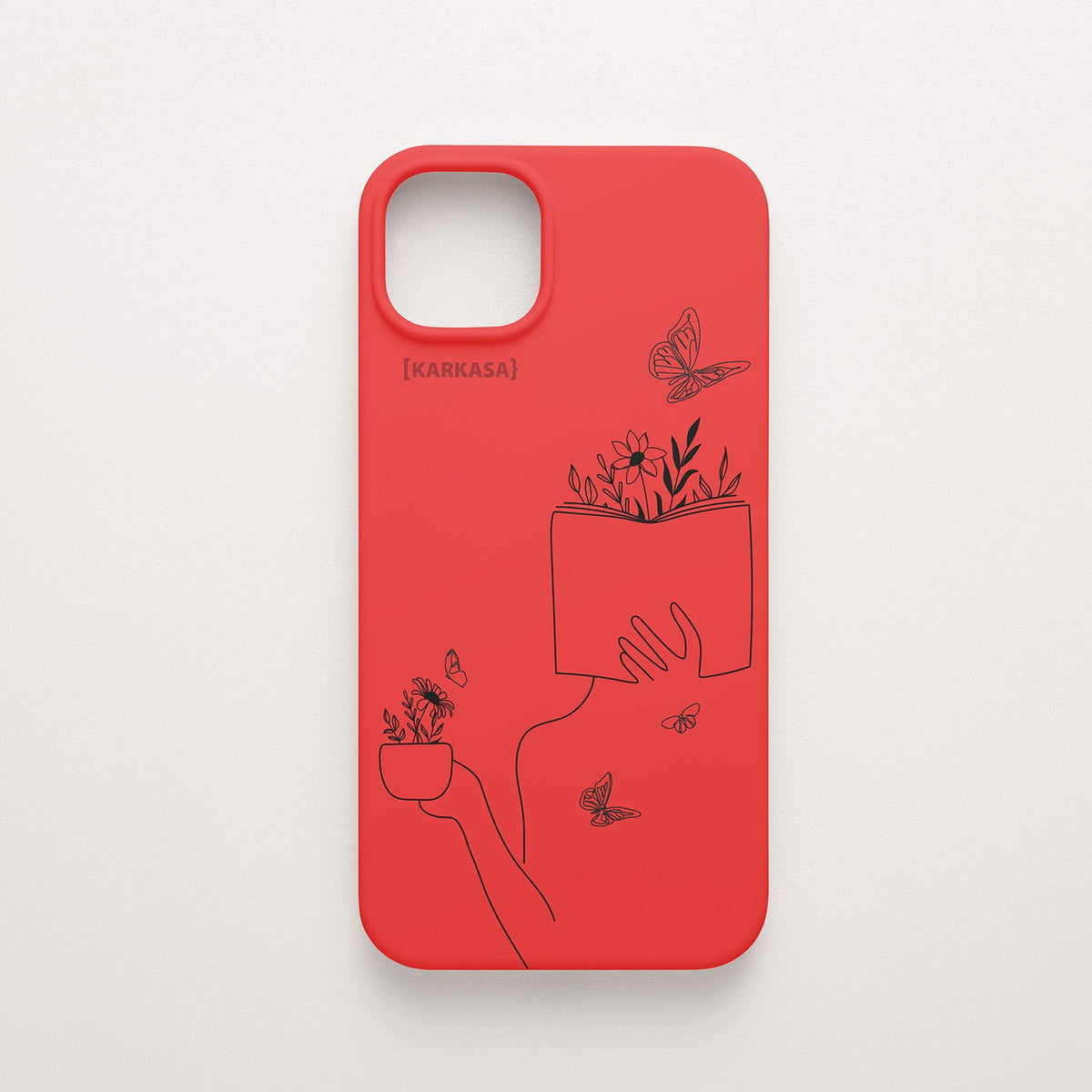 Funda de móvil KARKASA con ilustración lineal negra de una figura leyendo con flores y mariposas, en silicona mate Silk Touch roja.