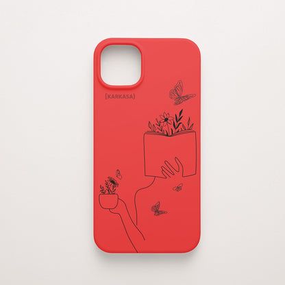 Funda de móvil KARKASA con ilustración lineal negra de una figura leyendo con flores y mariposas, en silicona mate Silk Touch roja.
