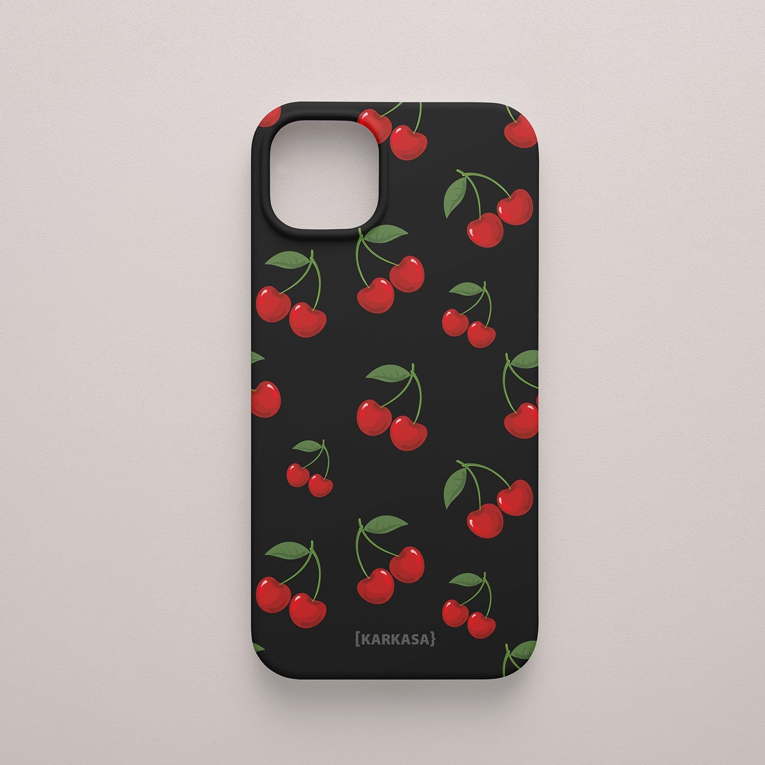 Funda KARKASA Silk Touch negra con estampado pop de cerezas rojas y hojas verdes. Carcasa estilo frutal aesthetic.