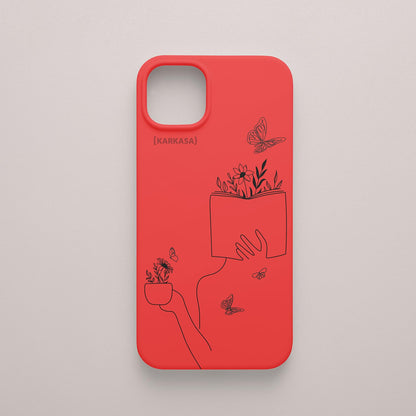 Funda de móvil KARKASA con ilustración lineal negra de una figura leyendo con flores y mariposas, en silicona mate Silk Touch roja.