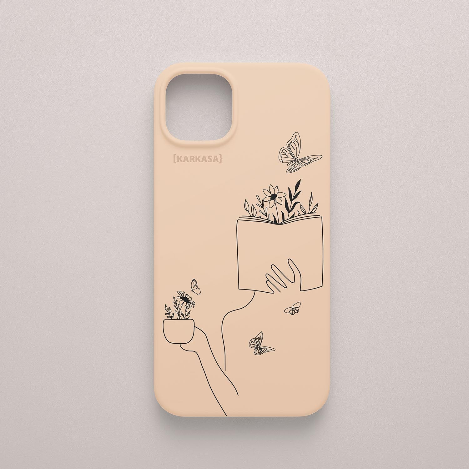 Funda de móvil KARKASA con ilustración lineal negra de una figura leyendo con flores y mariposas, en silicona mate Silk Touch rosa nude.