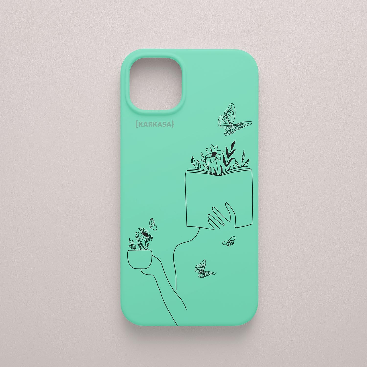 Funda de móvil KARKASA con ilustración lineal negra de una figura leyendo con flores y mariposas, en silicona mate Silk Touch verde menta.