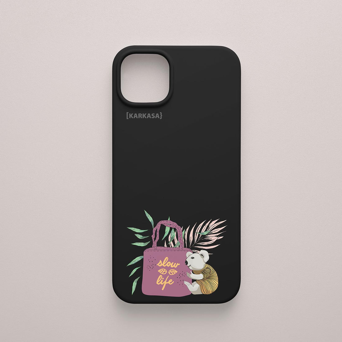 Funda KARKASA Silk Touch negra con ilustración de koala llevando un bolso rosa con la frase Slow Life y hojas tropicales. Carcasa estilo mindfulness.